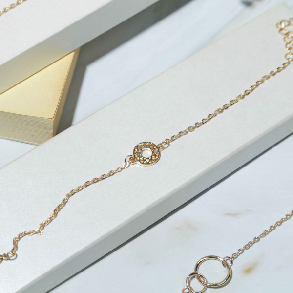 Yellow Gold Bracelet with Circle Shape in the Middle  Adorned with Stones Like Diamonds